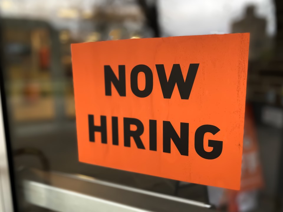 help wanted sign on business door by Catherine McQueen Getty Images