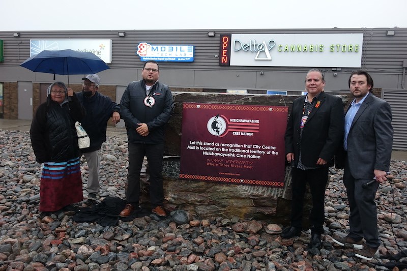 Nisichawayasihk Cree Nation councillor Willie Moore, third from left, Manitoba Keewatinowi Okimakanak Grand Chief Garrison Settee, second from right, and John Adriessenans of City Centre Mall after the unveiling of a monument acknowledging that the mall is in the traditional territory or NCN.        