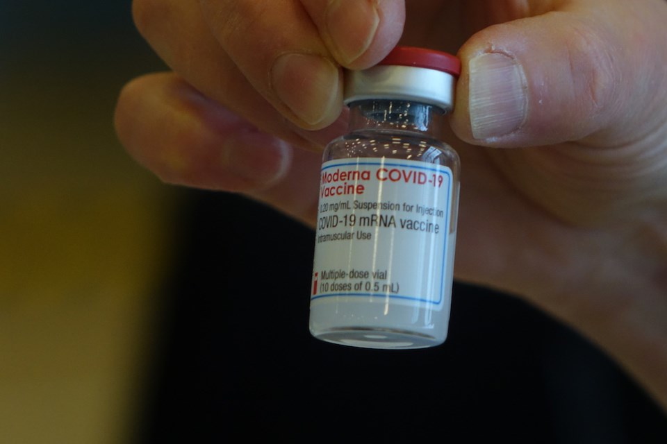 worker holds moderna covid 19 vaccine at thompsno vaccine supersite feb 1 2021