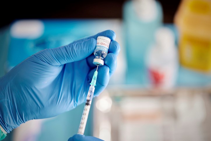 worker prepares covid 19 vaccine dose