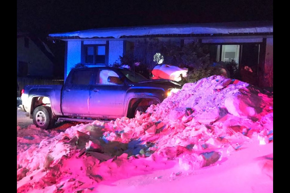RCMP photos show the aftermath of a collision that occurred March 14 when a pickup truck hit a parked vehicle in front of a house.
