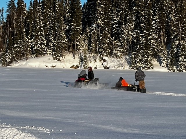 Nelson House RCMP used a toboggan towed by a snowmobile to transport three men stranded during extremely cold temperatures back to the community nursing station on Feb. 18.