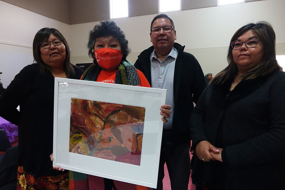 Sally Saunders, second from left, of York Factory First Nation, poses Dec. 8 with a painting she made in 1960 as a student at MacKay Residential School in Dauphin, flanked by her daughters Debra Brooks, left, and Martina Saunders, right, and her son Johnny Saunders, second from right.