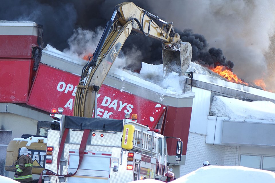 Firefighters from Thompson Fire & Emergency Service, Vale Manitoba Operations and the Paint Lake Volunteer Fire Department as well as heavy equipment operators battle a blaze at Shoppers Drug Mart in the Burntwood Plaza on the morning of March 9.