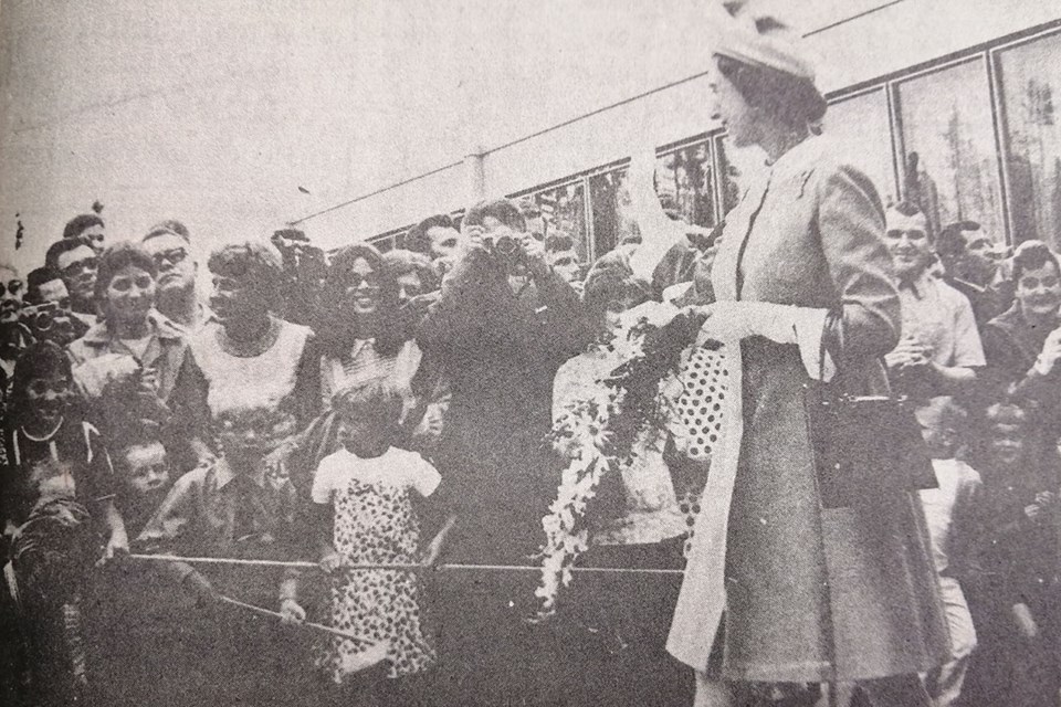 Queen Elizabeth II waves to the crowd at the Thompson hospital parking lot during a visit for a few hours on July 10, 1970.