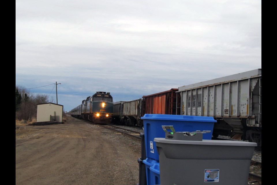 Bayline Food Buying Co-op grocery shipments awaiting pickup in Wabowden, being loaded onto a Via passenger train and unloaded from the train in Pikwitonei.