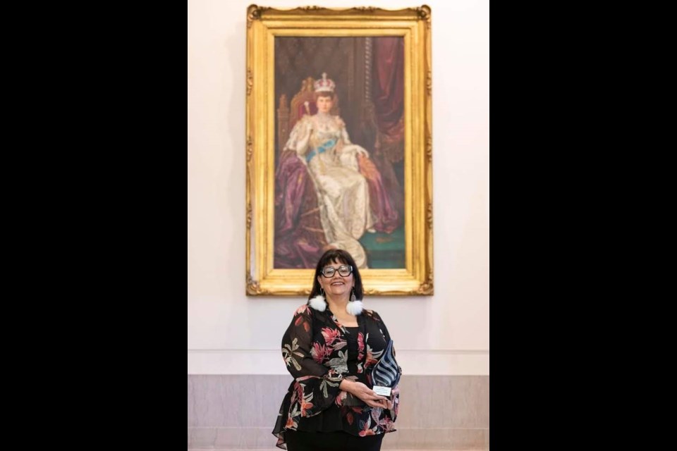 Hilda Anderson-Pyrz poses with her 2022 Empower Women award at the Manitoba legislature on Oct. 20.