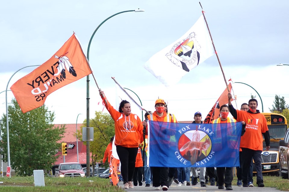 Members of Fox Lake Cree Nation and York Factory First Nation head out of Thompson on the morning of Sept. 21 during their 1,000-kilometre journey to Winnipeg. The walkers carried the flags of their First Nations and also a banner featuring hand prints made by schoolchildren.