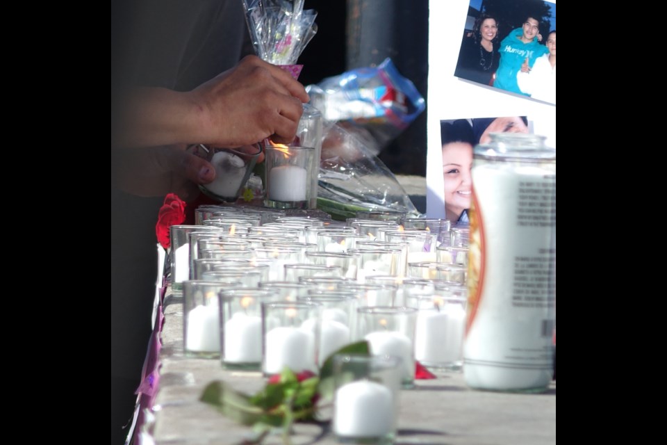 Attendees at a June 5 vigil in Thompson for Tessa Perry, who died by homicide in Winnipeg on May 28, light candles in her honour.