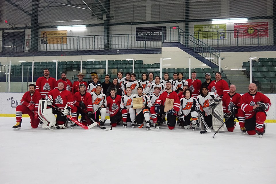 The RCMP squad and the under-18 Thompson King Miners shook hands and posed for a photo together at the conclusion of their April 6 hockey game, won 7-6 by the police team.