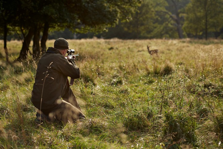 a-hunter-with-a-rifle-taking-aim-at-a-deer-by-klaus-vedfelt-getty-images