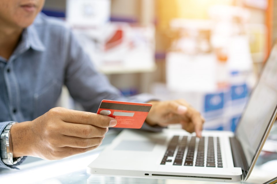 guy at laptop with credit card Witthaya Prasongsin Getty Images