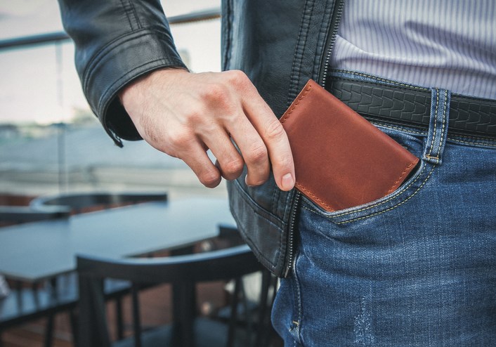 Men's hand wallet in the pocket - stock photo