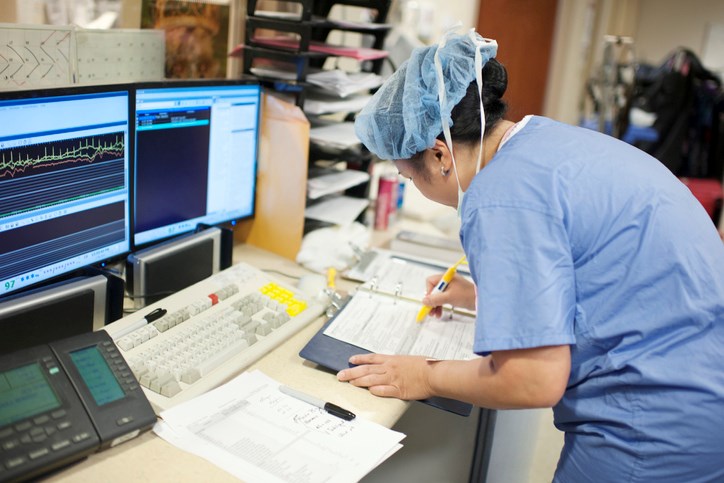 nurse filling out paperwork Reza Estakhrian Getty Images