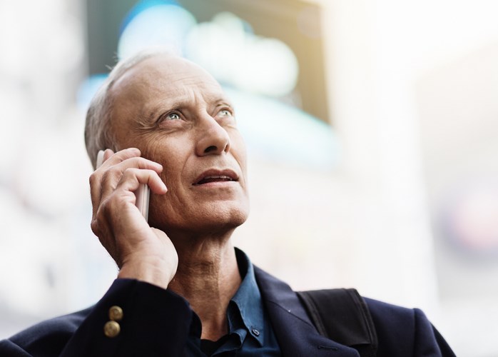 older man with phone up to ear by RapidEye Getty Images