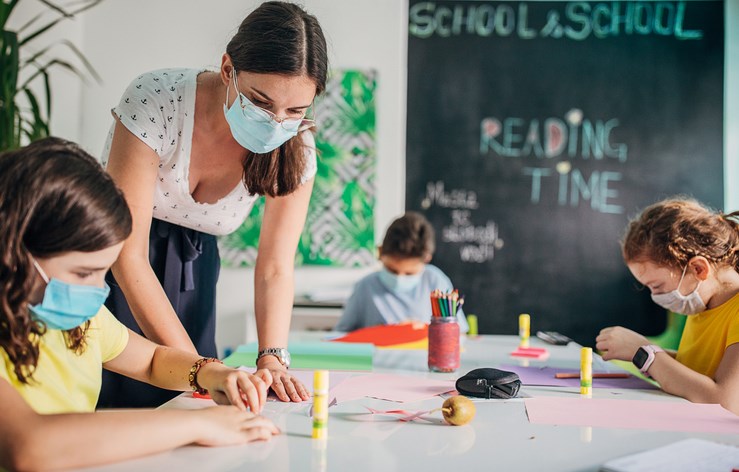 teacher and students in classroom with medical masks South_agency Getty Images