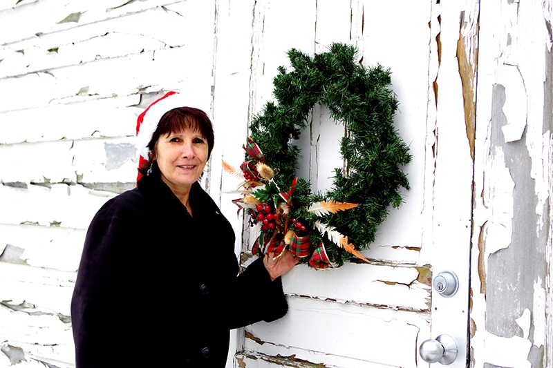 Pictured here at one of the annual Christmas celebrations, and currently working on the virtual yard sale, Helene Miller proves historic restoration is an all-year endeavour. 