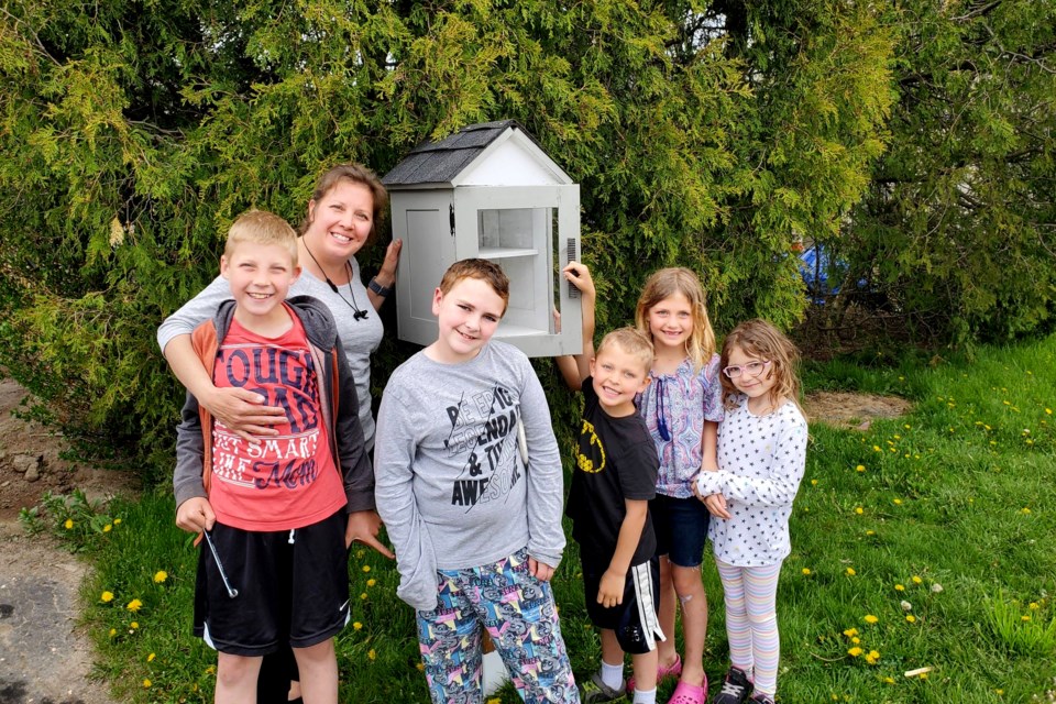 Karen Schilstra, her children and a friend pose in front of the free lending library the Schilstra family erected in their neighbourhood, just one of the many perks of Thorold's Neighbourhood Hub program. SUBMITTED PHOTO