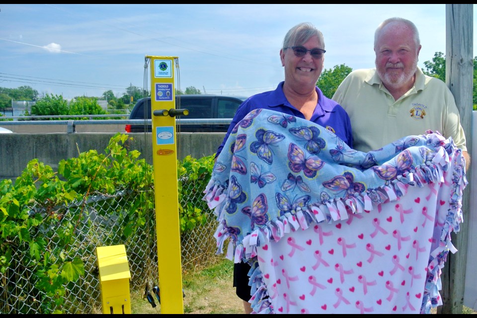 Patricia and John Wilson pose with two of their projects: the bicycle repair station at Lock 7 (l) and fleece blanket. Bob Liddycoat / Thorold News