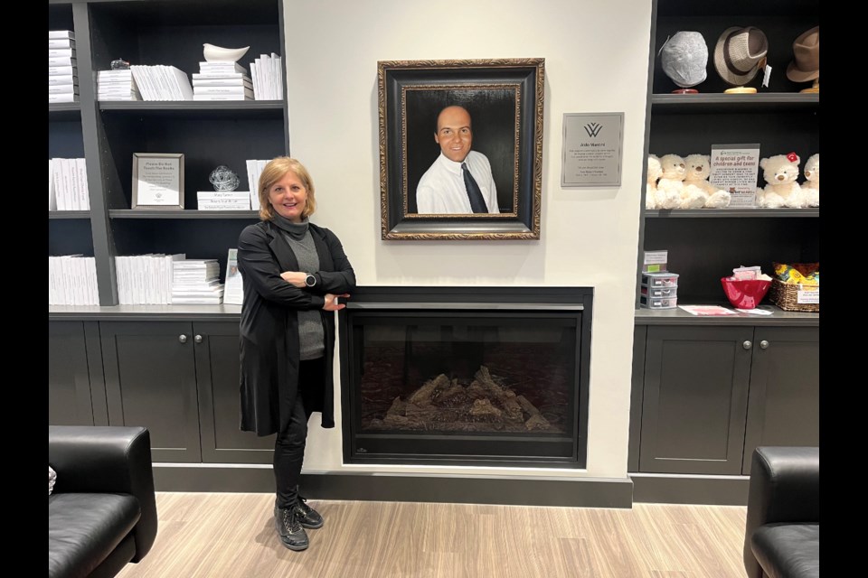 Ann Mantini-Celima next to a portrait of her late brother Aldo who inspired her to start Wellspring Niagara.