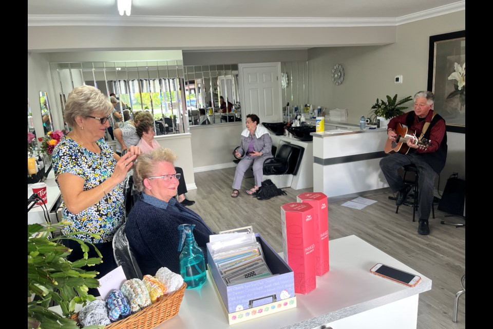 Chris Scott regaled customers at Vicky's Hair Salon with a concert on Friday morning.