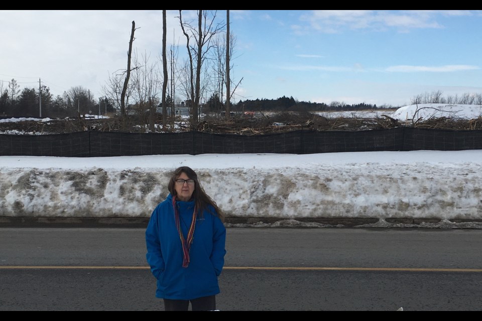 Carla Carlson in front of the destroyed frog pond.