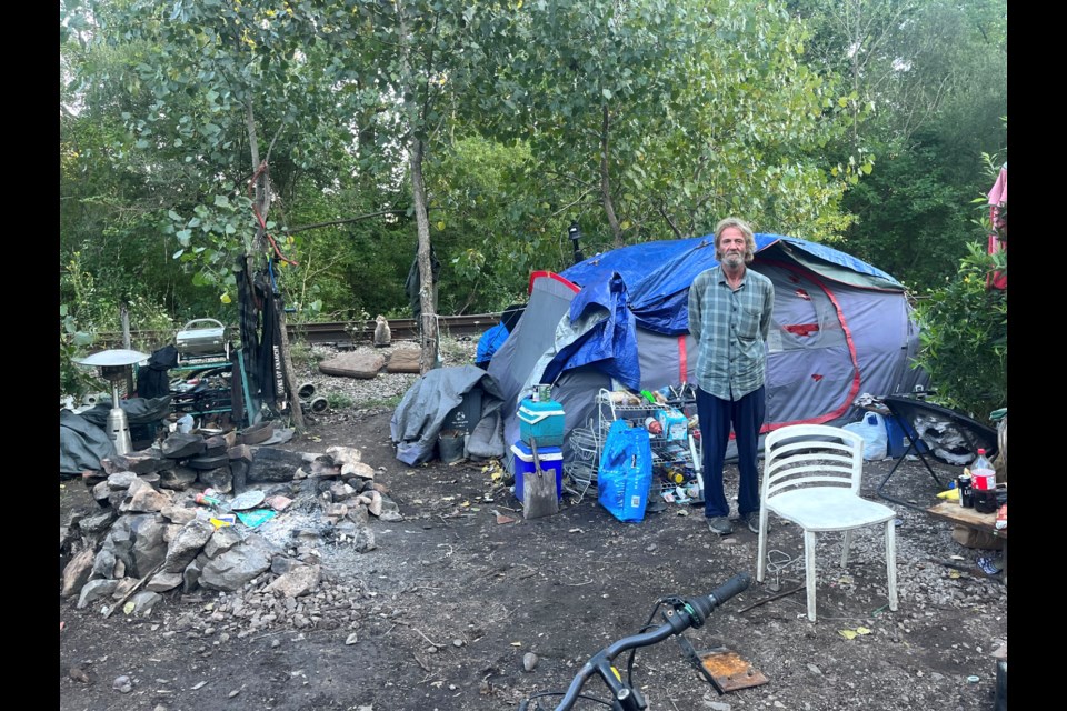 Gary Smith in front of the tent he has been sleeping in for the past year. His partner Crystal is not photographed because she is worried her family will find out she is homeless.