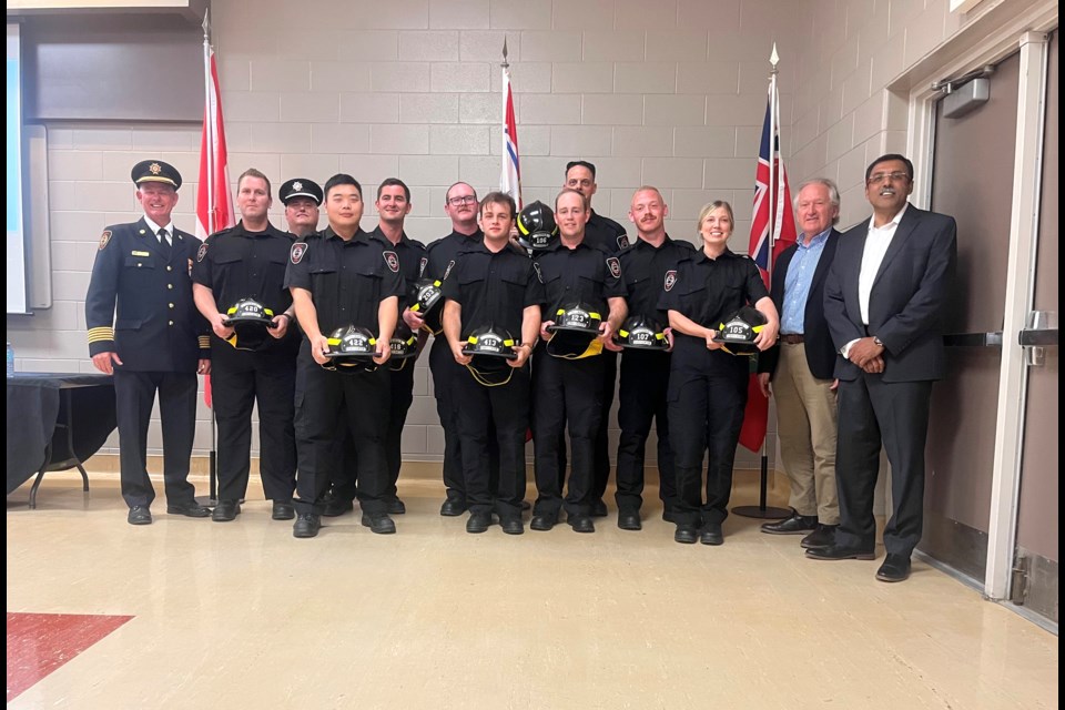 The 2022 graduating class of volunteer firefighters, together with Fire Chief Terry Dixon, Captain of Training Mike Pittaway, Mayor Terry Ugulini, and the city's CAO Manoj Dilwaria.