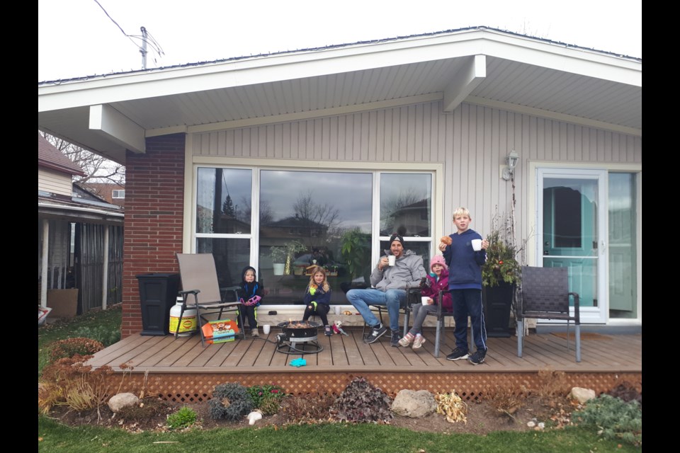 Karen Schilstra's husband Terrence Schilstra and their four kids, hanging out on their porch.