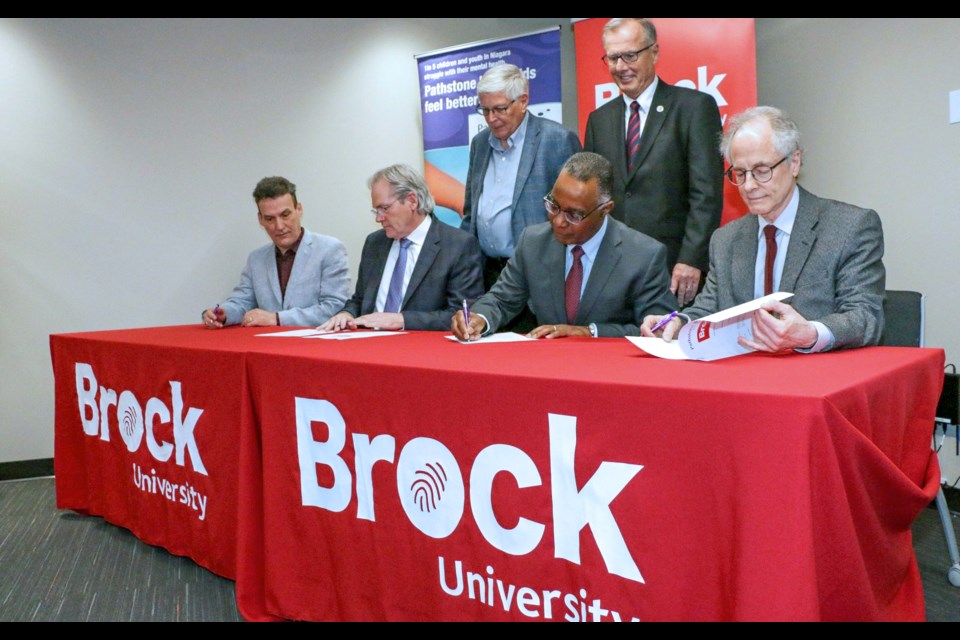 Pathstone Mental Health and Brock University signed a Memorandum of Understanding Friday, March 22. Pictured front row from left: Bill Helmeczi, Pathstone Director of Strategic Planning, Standards, and Practices, Pathstone CEO Shaun Baylis, Brock President Gervan Fearon and Brock Professor Sid Segalowitz. Back row are Pathstone Board Chair Elco Drost, left, and Brock Board Chair Gary Comerford. Photo Brock Press