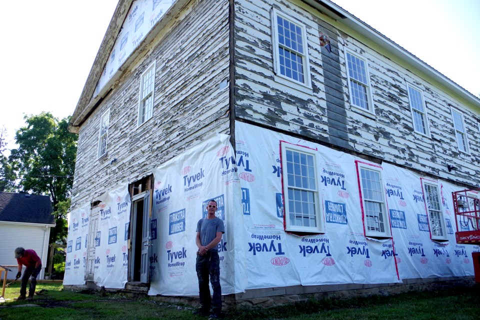Andrew Prescott  of Square Roots Restoration overseeing the siding replacement at the Beaverdams Church. Bob Liddycoat / Thorold News