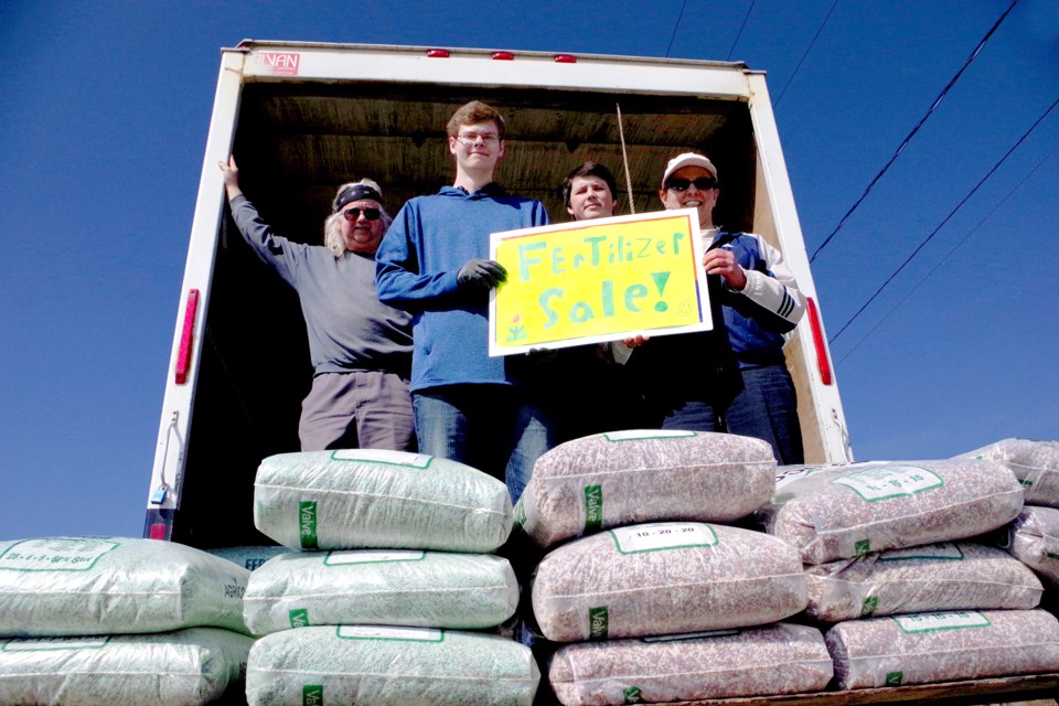 Thorold Secondary students Patrick Lopoyda and Tyler Sebastian pitched in to earn community service hours at the 10th annual fertilizer fundraiser, which continues today (Sunday) until 4 p.m. Bob Liddycoat / Thorold News