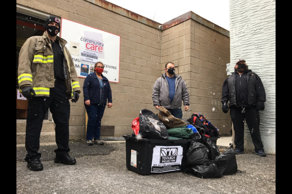 Not all heroes wear capes, but they tend to be masked. From left: Steven Radcliffe, Thorold Volunteer Firefighters, Maxine Hutchins, Community Care, James Symons from ToolBox Niagara and Matt Cuthbert, Niagara Furniture Bank. Photo: Ludvig Drevfjall/Thorold News