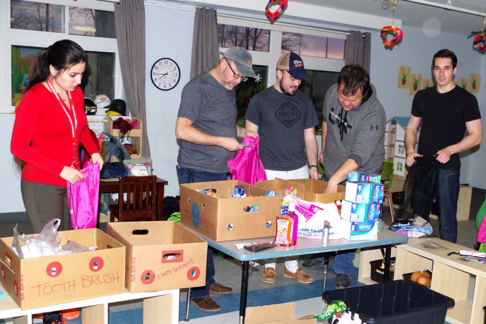 Pictured (l-r) Sasar Manafi,  Chaplain Allan Gallant, Tyler Rigby, James Symons, and Noah Chasse, pack up products for homeless youth. Bob Liddycoat / Thorold News