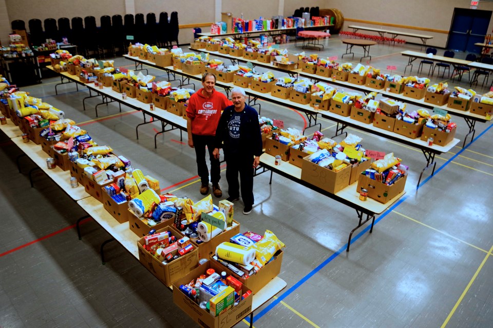 Volunteers Ben and Aldo helped pack up heaping boxes for 70 families. Bob Liddycoat / Thorold News