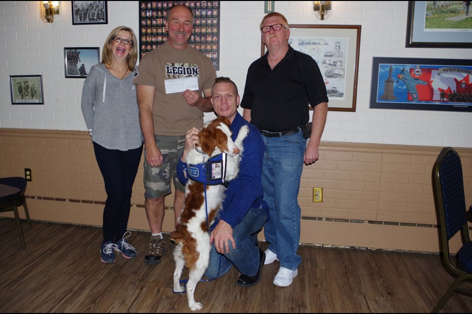 Jeannie Soper, Ken Smalko, and Thorold Legion president Eric Cuthbert (r) present a cheque for $1,000 to Graham Bettes and Maverick, to support jiu jitsu training for Bettes' PTSD support group. Bob Liddycoat / Thorold News