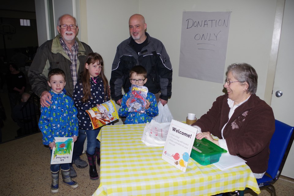 Hudson, Ava, Ken, Logan and Michael Dobbie loaded up on books at the St. Andrew's Church book and bake sale Saturday morning. Bob Liddycoat / Thorold News