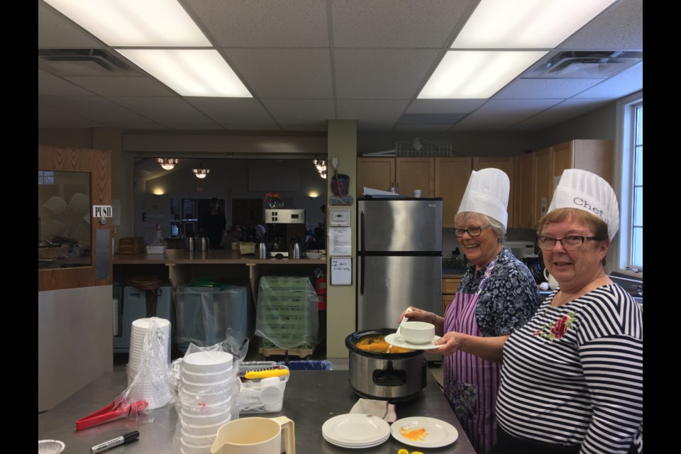 Gail Bradley and Judy Riley have been serving hot soup at the St John's church for three years. (Photo: Ludvig Drevfjall/Thorold News)