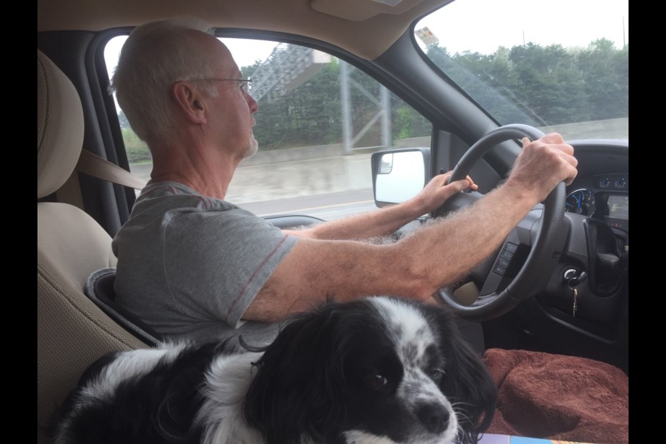 Richard Pinter at the wheel on the way home to Canada with travel mascot Natalie at his side. Photo: Supplied