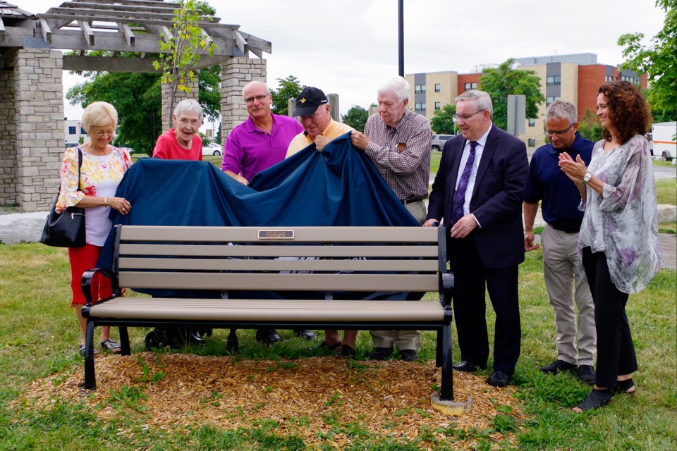 A commemorative bench is unveiled by (l-r) former Liaison Committee members Maureen Barker and Mary Lorimer, Thorold Councillor John Kenny, former St. Catharines Mayor Tim Rigby,  former committee member Bryant Prosser, Regional Chair Jim Bradley, Niagara Region CAO Ron Tripp and acting Commissioner of Regional Public Works Catherine Habermebl.  Bob Liddycoat/Thorold News