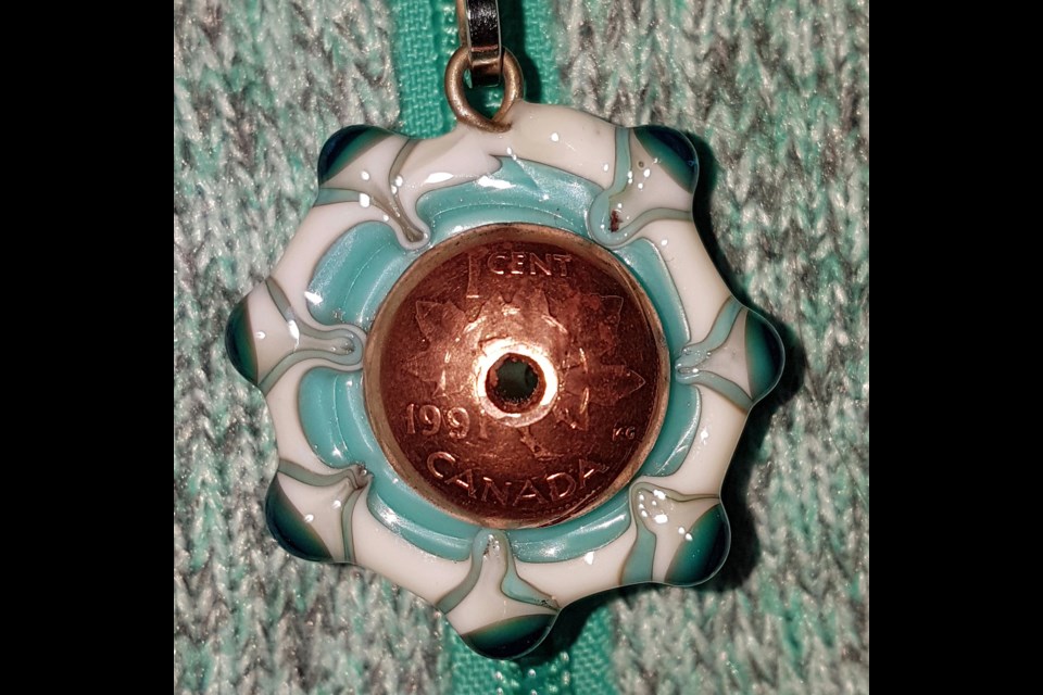 Following ancient Italian tradition, Karen Reece melts glass with a torch to make beads, then creates distinctive jewellery, infusing the beads with origami, pennies, and other unique features. Photo/submitted