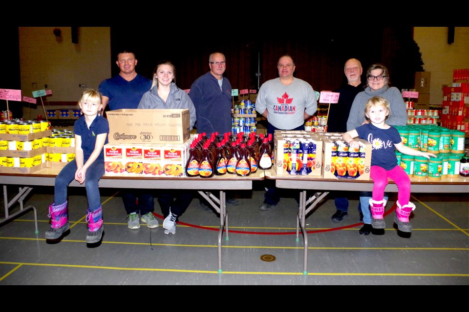 On hand to sort the food were: Rhonda Kenny and boyfriend Pat Todd, daughter Aime and son-in-law Scott
Grant  and their children Korrie, age five and Alaina, age three, John Kenny, Albert Ciamarra. 
Pictured (l-r) are Korrie, Scott, Aime, John, Albert, Pat and Rhonda. Absent were Tim and Mike Kenny and families. Cathy Pelletier/ThoroldNews
