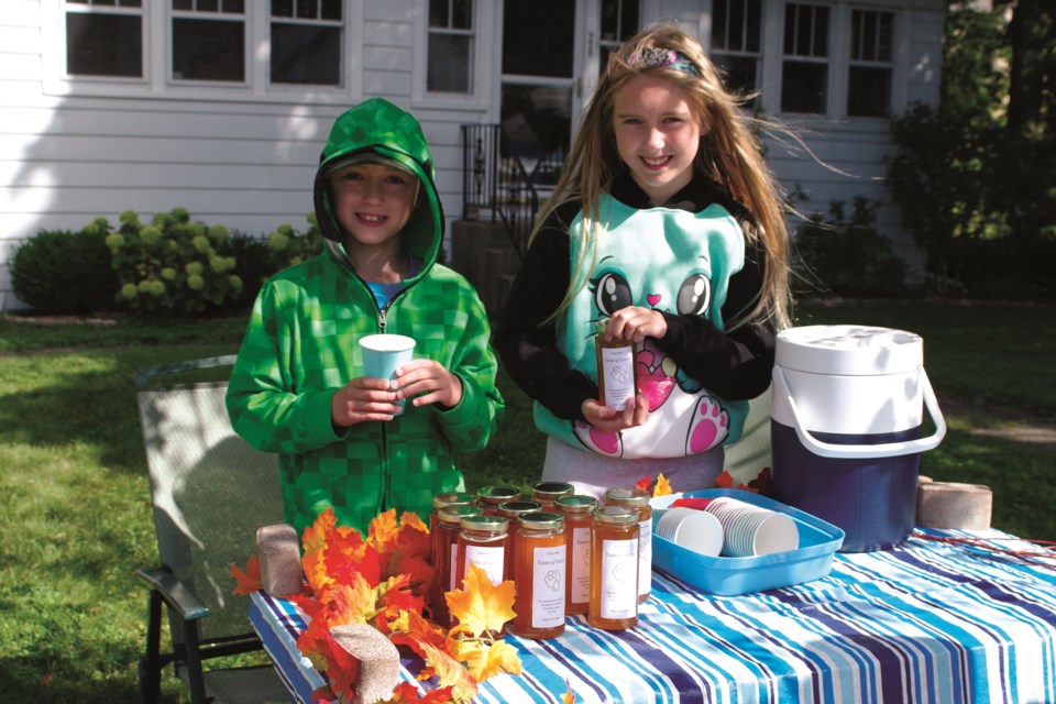 Ben and Jessie MacQuarrie took advantage of Thorold's Community-Wide Garage Sale traffic Saturday to sell lemonade, along with their parents' homemade honey. Bob Liddycoat / Thorold News