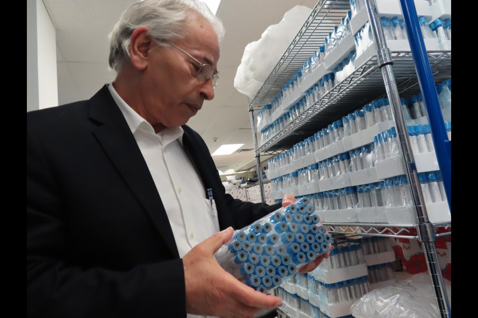 Dr. Yousef Haj-Ahmad inspects a batch of vials at Norgens Thorold facility. Photo: Ludvig Drevfjall/Thorold News