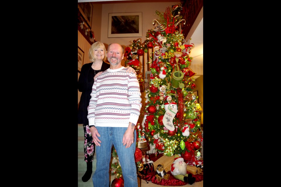 Claudia and Mike Niles greeted their guests in their foyer beside the first of eight Christmas trees decorated in their home A ninth stand on the front porch. Bob Liddycoat/ThoroldNews