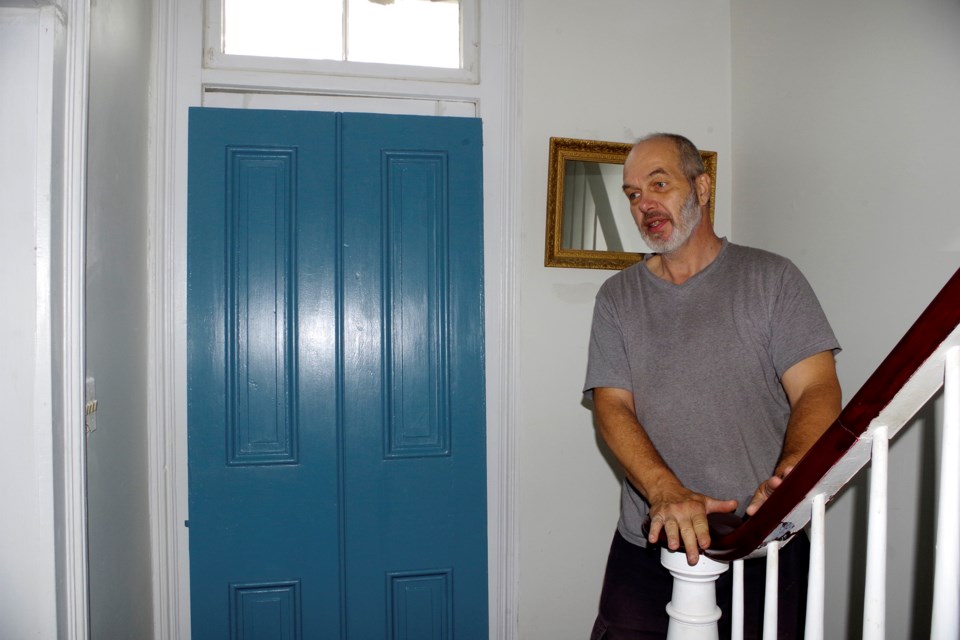 Andre Wagner begins the painstaking process of restoring a heritage home, which includes finding reproduction period doors, and refinishing the fine wood in the banister. Bob Liddycoat / Thorold News