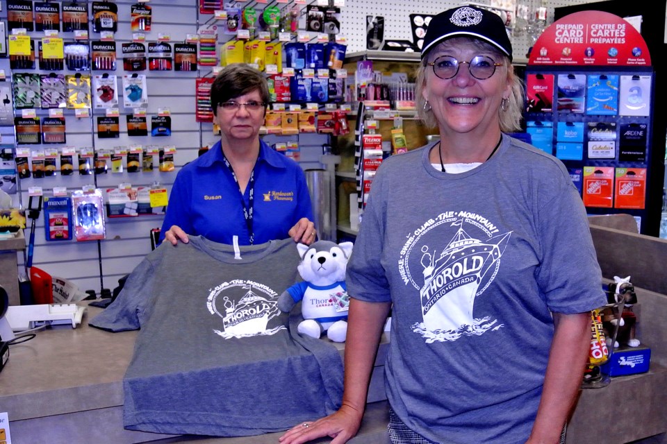 Susan Horn, left, and Thorold tourism agent Sue Morin display the new Thorold T-shirts and caps now on sale at Henderson's Pharmacy. Bob Liddycoat / Thorold News