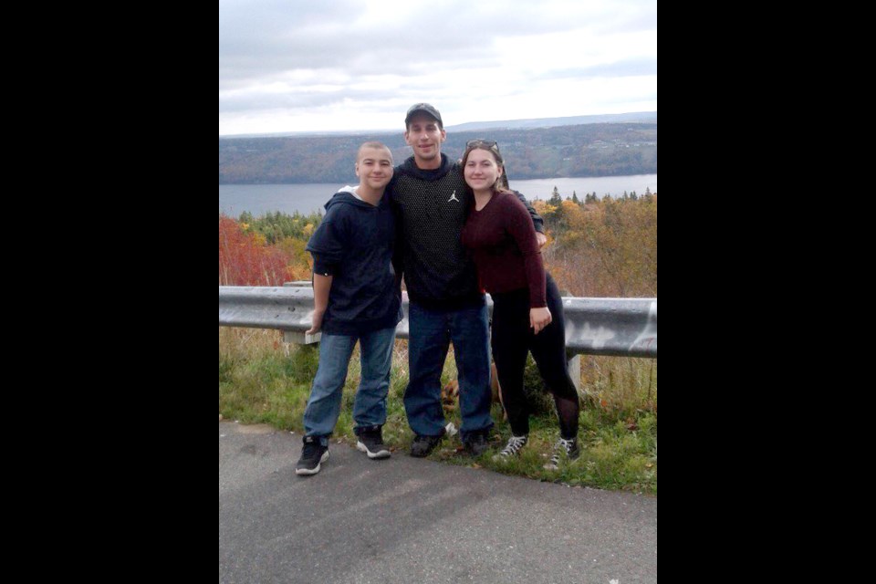 Michael Leblanc, centre with wife Jennifer and son, Lucas. Submitted Photo