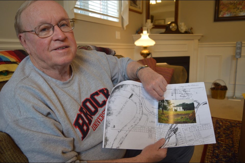 Local historian, Tom Russell holds an old map of Thorold and a picture of where St. Paul’s Anglican church was located in honour of black history month. (Photo: Gloria Katch/Thorold News)