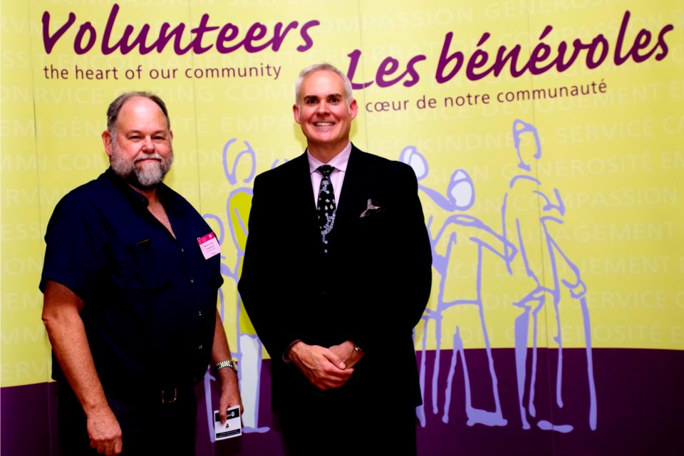 Tony Vandermaas receiving his Ontario Volunteer Service Award for 20 years of service to the Thorold Public Library from Chris Saunders, program lead with the Ontario Honours and Awards Secretariat. Bob Liddycoat / Thorold News